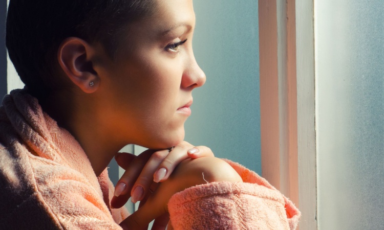 Young Cancer Patient Standing in Front of Hospital Window.